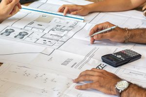 reviewing a renovation blueprint